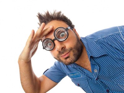 man with thick glasses looking at something