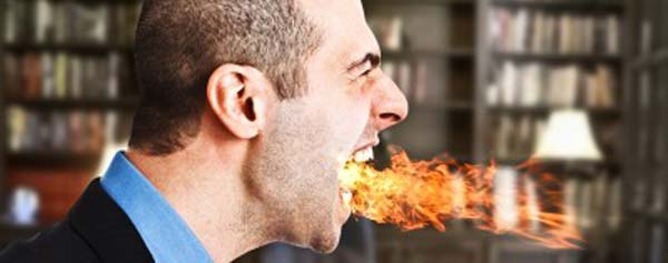 man blowing fire out of mouth