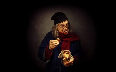 scrooge holding a gold coin